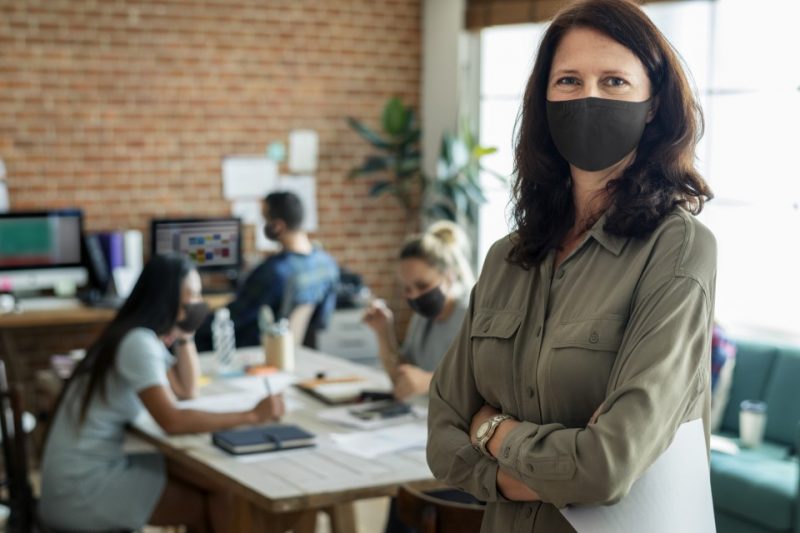businesswoman-in-face-mask-at-the-office-woman-wearing-face-mask-in-the-office-covid-19-safety-protocols-latest-updates-working-enviroments
