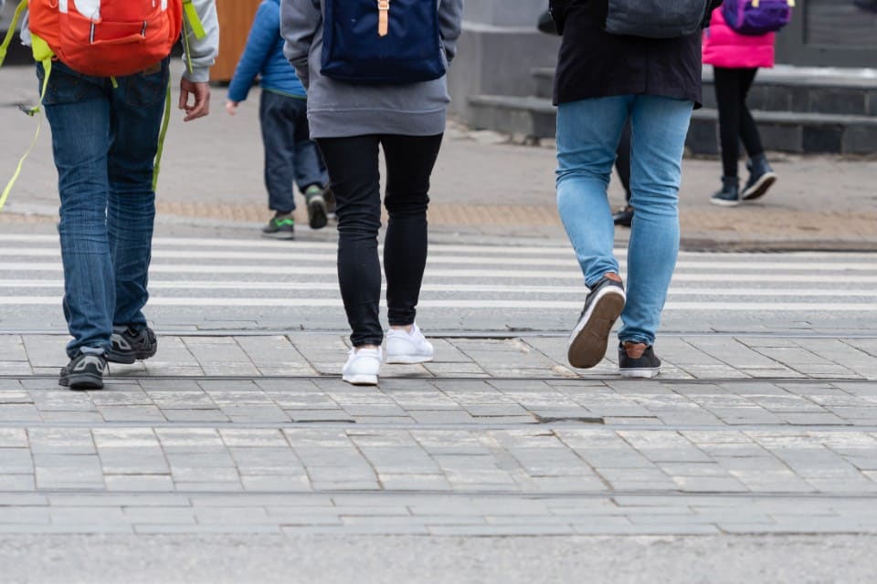 Feet of pedestrians walking on the crosswalk – image street-people-covid-england-no-need-self-isolate-rapid-antigen-test